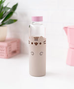 Front view of Pusheen Glass Water Bottle. Glass water bottle has a silicone sleeve that covers ¾ of the bottle for protection. The grey sleeve features Pusheen the Cat with dark grey and brown details including eyes, whiskers, mouth, head stripes, and front paws. 