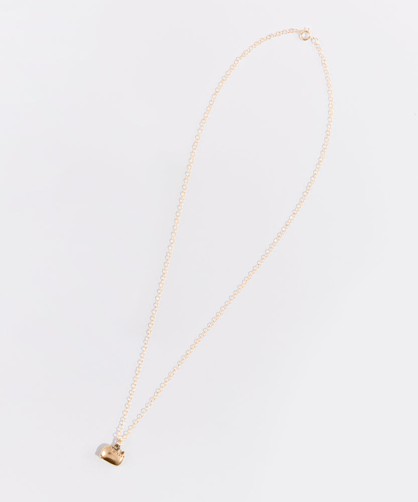 Full view of the gold charm necklace on top of a white background.