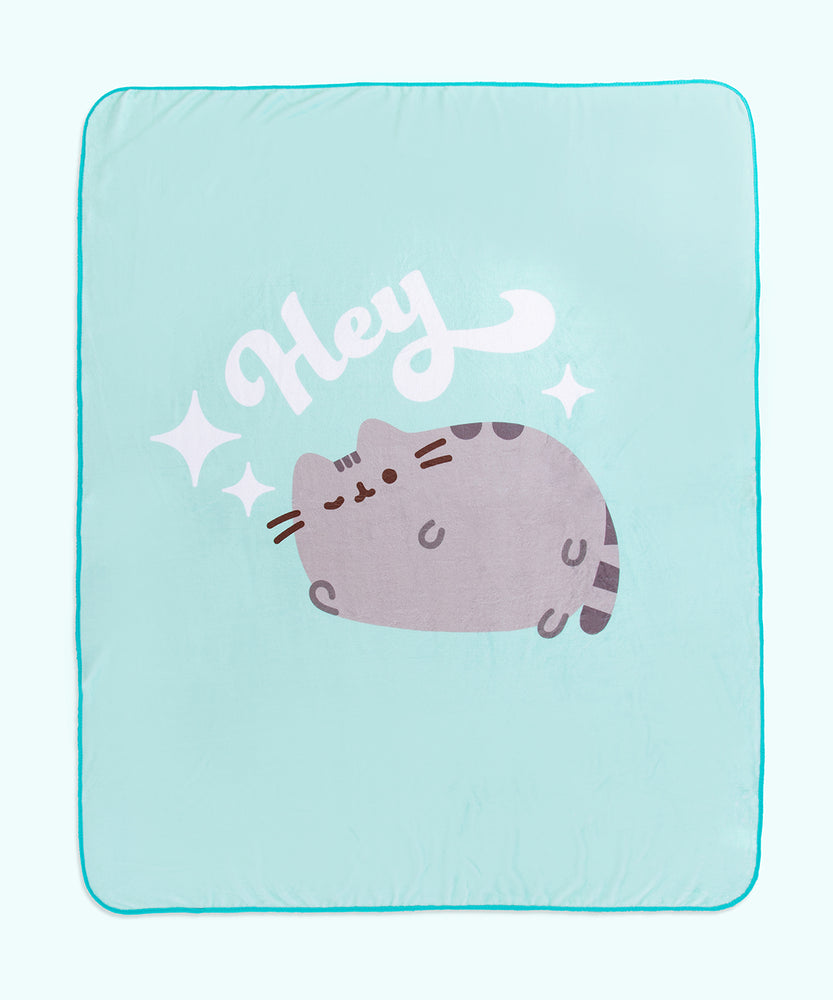 Full view of Pusheen Hey Throw Blanket. A winking Pusheen rests lays below the phrase “Hey” and is surrounded by white stars. 