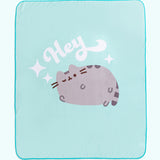 Full view of Pusheen Hey Throw Blanket. A winking Pusheen rests lays below the phrase “Hey” and is surrounded by white stars. 