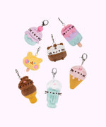 Styled view of the surprise plush keychains with Pusheen shown as ice cream varieties. The keychains include Ice Cream Cake Pusheen, Strawberry Ice Cream Pusheen, Ice Cream Cup Pusheen, Milkshake Pusheen, Ice Pop Cheek, Ice Pop Pusheen, and Dipped Cone Pusheen. 