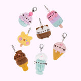 Styled view of the surprise plush keychains with Pusheen shown as ice cream varieties. The keychains include Ice Cream Cake Pusheen, Strawberry Ice Cream Pusheen, Ice Cream Cup Pusheen, Milkshake Pusheen, Ice Pop Cheek, Ice Pop Pusheen, and Dipped Cone Pusheen. 