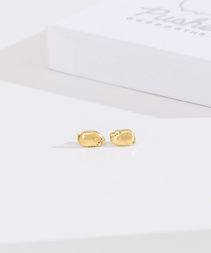Front view of gold vermeil finish of Lazy Stud Earrings. The earrings are an unmatched pair of Pusheen sitting in two different lounging poses.
