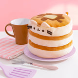 Right quarter view of the Pusheen Pancake Squisheen. Pusheen's cream-colored ears sit at the top edge of the pancake stack and three light brown stripes sit between her ears. 