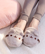 Model wears Pusheen Plush Slippers. Slippers included embroidery of Pusheen the Cat's face, ribbon whiskers, and soft ears that extend off the toe box of the slippers.  