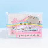 Front view of the enclosed Pusheen Rainbow Stationery Set. The items in the set are encased in a clear plastic zip pouch with a graphic of Pusheen the Cat riding a blue, yellow, and pink wave. Next to Pusheen is the phrase “You Go This.” Accessories included in the pouch are pink, cream, yellow, and light blue multi-colored. Pouch sits on a white surface in front of a light blue background.  