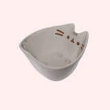 Left quarter view of the Ramen Bowl shows Pusheen's light grey feet printed on the inside bottom of the character-shaped bowl.