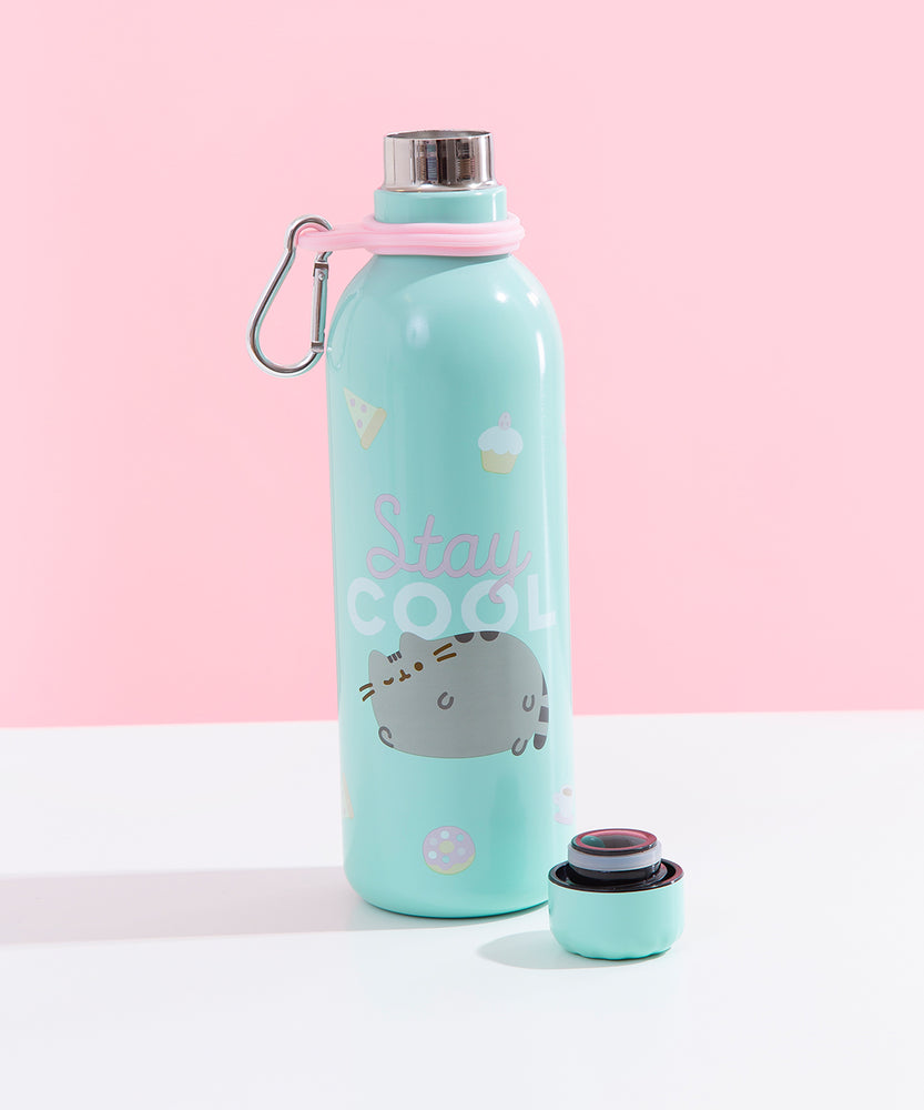 The Pusheen Stainless Steel Waterbottle with it’s cap removed and placed besides it, placed in front of a white and pink background. The Pusheen design on the bottle does not have any outlines, giving the graphic a soft look. The word ‘Stay’ is in pink cursive and the word ‘Cool’ is in white arial. 