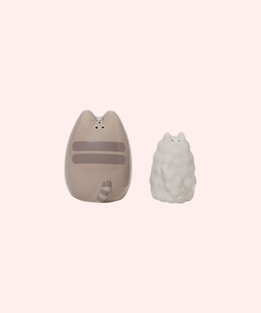 Back view of the Pusheen & Stormy Salt & Pepper Set. On the Pusheen shaker, three holes are placed behind Pusheen's ears to allow pepper to dispense when shaken. The Stormy shaker has two holes to allow salt to dispense when shaken. 
