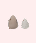 Back view of the Pusheen & Stormy Salt & Pepper Set. On the Pusheen shaker, three holes are placed behind Pusheen's ears to allow pepper to dispense when shaken. The Stormy shaker has two holes to allow salt to dispense when shaken. 