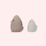 Left side view of both the Salt and Pepper shakers. The Pusheen shaker has Pusheen's classic back stripes and stripped tail that can be seen at this angle. The Stormy shaker has Stormy's fluffy, textured tail.