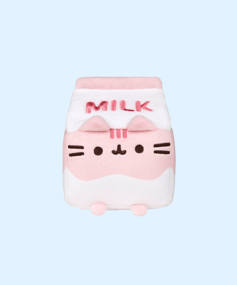 A close-up front view of the Strawberry Milk Sips Plush facing forward on a light blue background. 