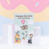 Front view of Pusheen the Cat's Guide to Everything. Little blue book features Pusheen, Bo the Parakeet, Sloth, Cheek the Hamster, Little Sister Stormy, and Little Brother Pip characters on the cover artwork. The propped up book is surrounded by three white cubes while the pink, yellow, and light blue background emulates an ice cream cone drip with sprinkles.