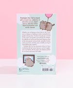 The back of the Pusheen the Cat book resting on top of a white desk. The back cover features copy, illustrations of Pusheen floating with a balloon and Pusheen in front of a computer. The barcode and publisher information is listed at the bottom of the book.