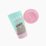 The Pusheen Travel Mug with it’s lid removed and placed to the side. The lid comes with a stopper molded in the lid that allows the hold to be opened and closed. The ‘Let’s’ is depicted in a bold white arial font, while the ‘do this’ is depicted in a pink cursive.