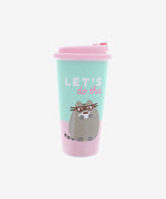 A pink and mint travel mug. The lid is pink. The mug is pink on the bottom and mint on top, with Pusheen in glasses drinking a dark beverage out of a white mug. Above Pusheen is the text "Let's do this" in white and pinkA plastic teal and pink travel mug with a pink lid with a stopper on it. The mug features a lineless illustration of Pusheen sitting upright, wearing square glasses and a coffee cup, the text ‘Let’s do this’ written above her. 