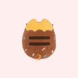 Back view of the plush shows Pusheen’s classic lines ar her back with her striped tail that is yellow and brown on this Chocolate Dipped Cookie Squisheen. 