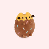 Right quarter view of Chocolate Dipped Cookie Squisheen. In the brown lower portion of the plush there is a scalloped edge that meets the yellow portion of Pusheen’s head and ears. 