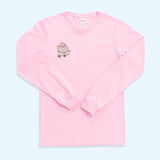 A baby pink graphic long-sleeve tee against a light blue background. The unisex t-shirt has a screen-printed graphic on the right side of the wearer’s chest. The shirts’ sleeves are folded to show the length. 