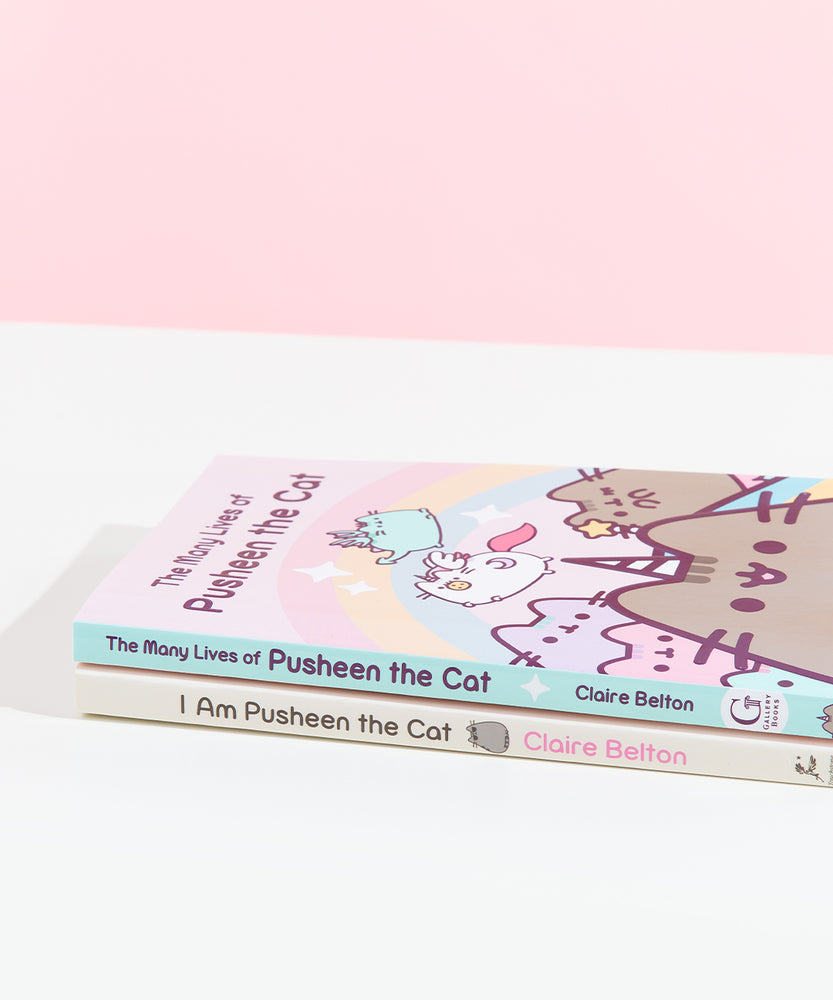 The Many Lives of Pusheen the Cat stacked on top of the previous Pusheen book, I Am Pusheen the Cat. Both books are paperbacks of similar length, though the spine for Many lives is mint colored with purple font and a white sparkle, while the first book is a light yellow with brown and pink text with a sunglasses wearing Pusheen on the spine.