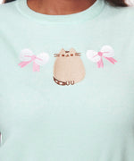 Close-up of embroidery on the front of the Pusheen Rib Knit Sweater. Pusheen sits facing forward with a smile of her face.