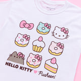 A close up of the screen print graphic on the Hello Kitty x Pusheen tee. The donuts on the tee all have cat ears and a pink Hello Kitty bow. All of the donuts save for the rightmost donut have sprinkles, the green donut having white sprinkles and the white and pink donut having dark pink sprinkles.