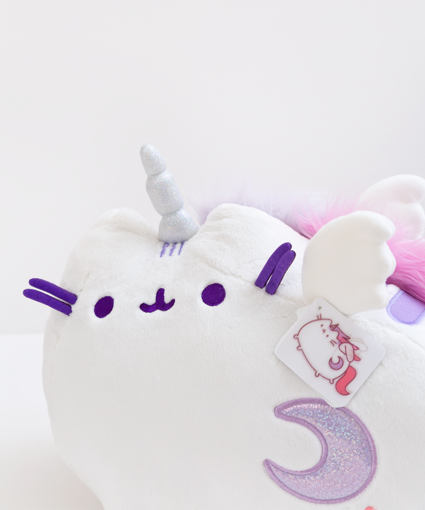 Close up of Super Pusheenicorn’s face. There are three light purple head stripes in between Super Pusheenicorn’s ears, emerging from her sparkly silver horn.