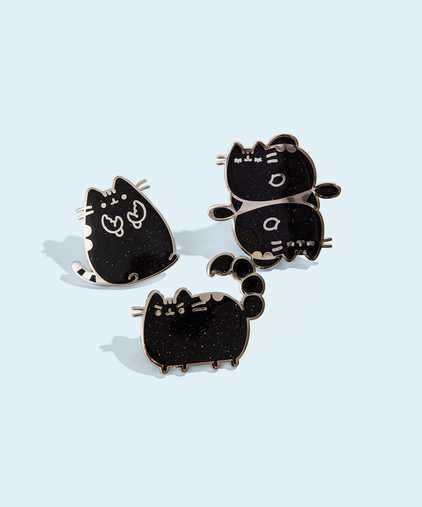 Group photo of three of the metallic Pusheen horoscope pins, featuring Pusheen as the three horoscope signs, Cancer, Scorpio, and Pisces.