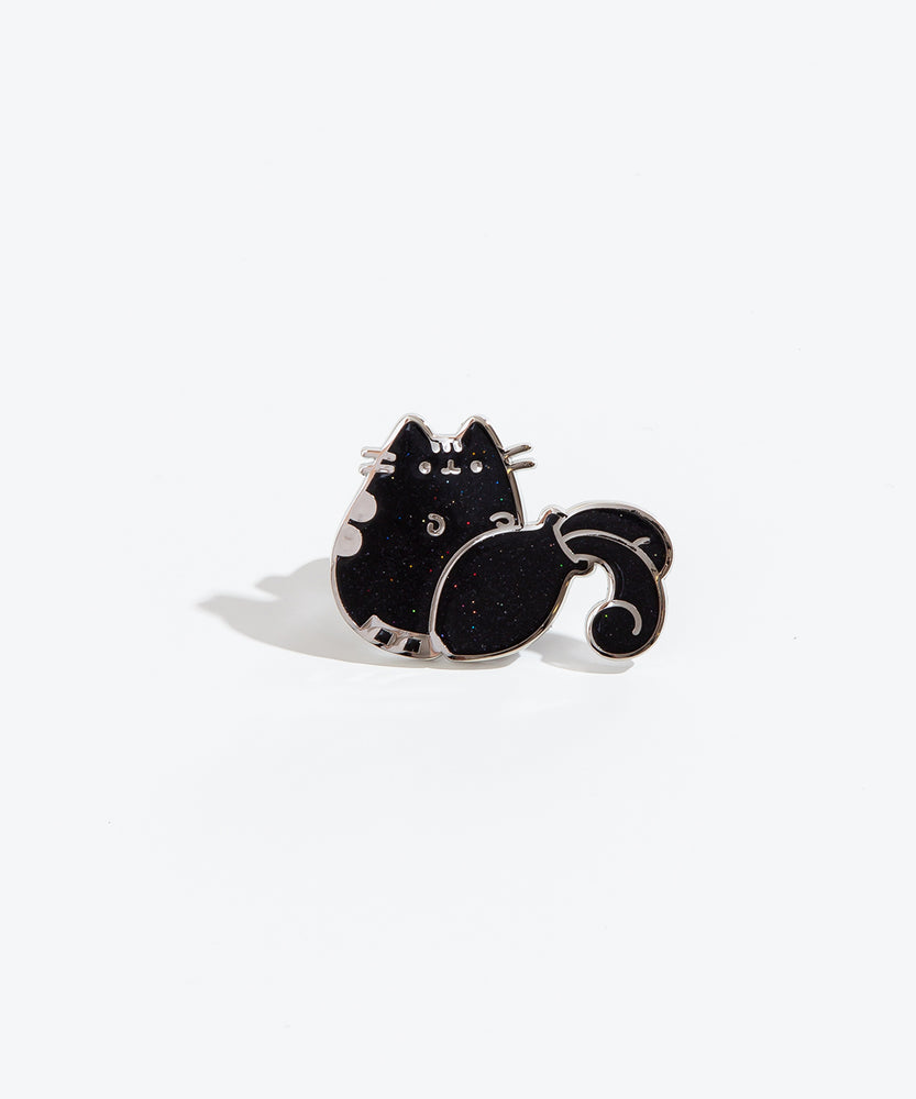 The Aquarius pin on a white background. The pin features a Pusheen knocking over a vase, causing water to spill out. The pin is black with multicolor sparkles and a silver outline.