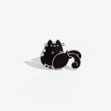 The Aquarius pin on a white background. The pin features a Pusheen knocking over a vase, causing water to spill out. The pin is black with multicolor sparkles and a silver outline.